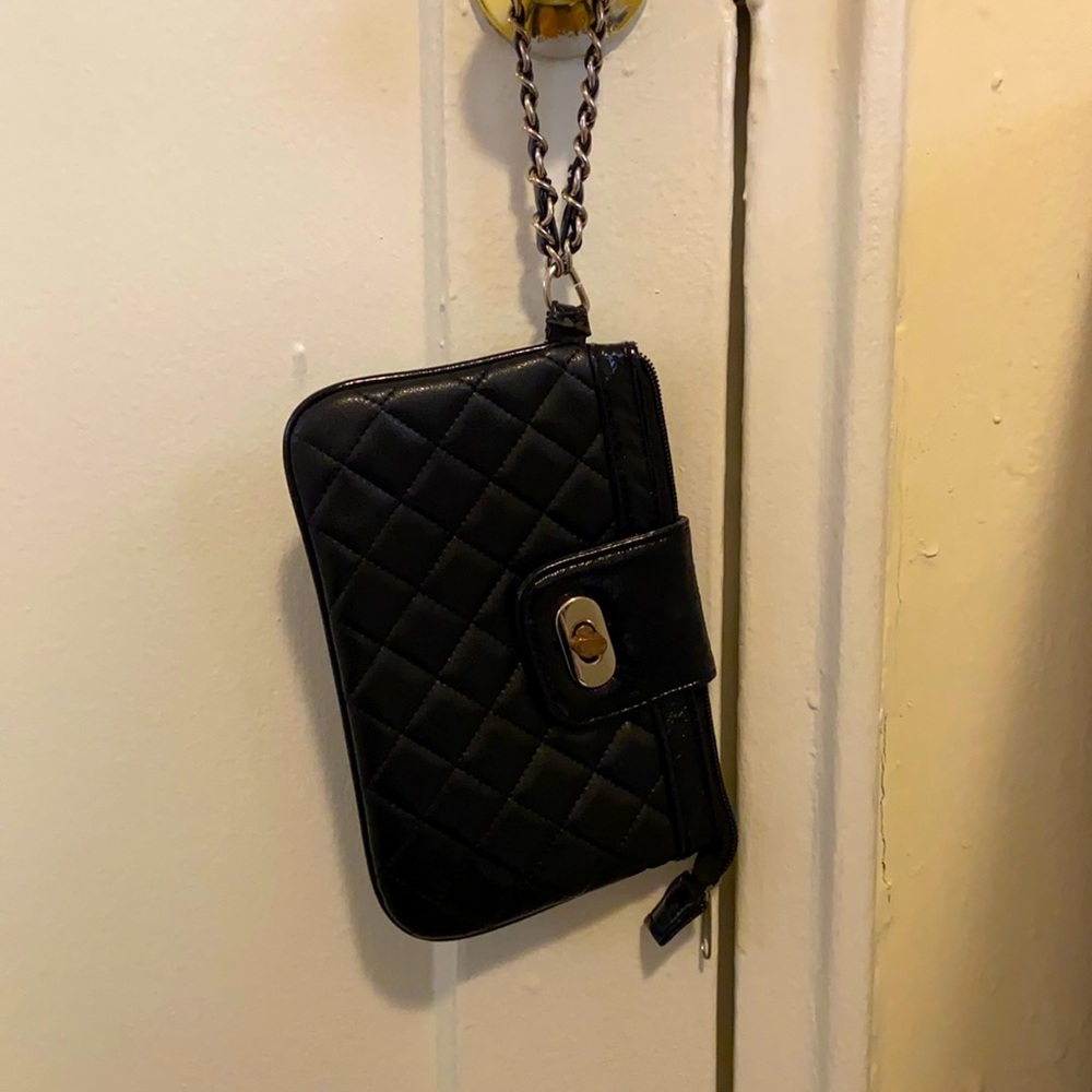 A small black clutch with silver detailing.